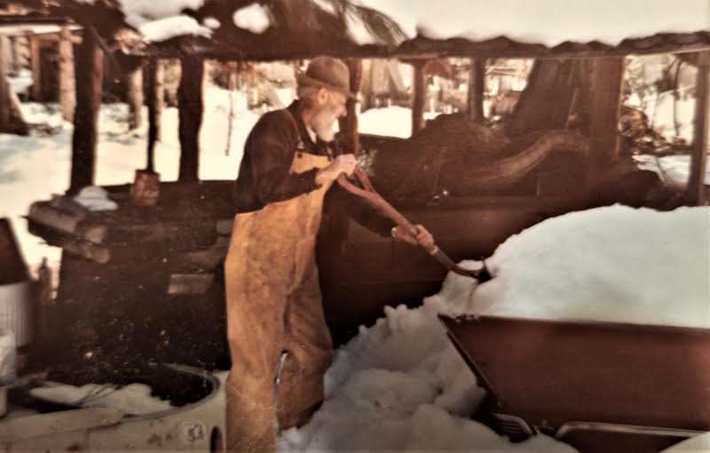 Woody shoveling snow.