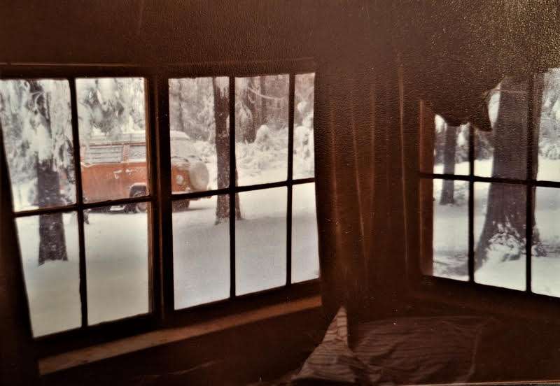 One of my favorites. Inside Woody's cabin, looking out the window. There was snow on the ground then and you can see Annie's and my VW camper parked outside.